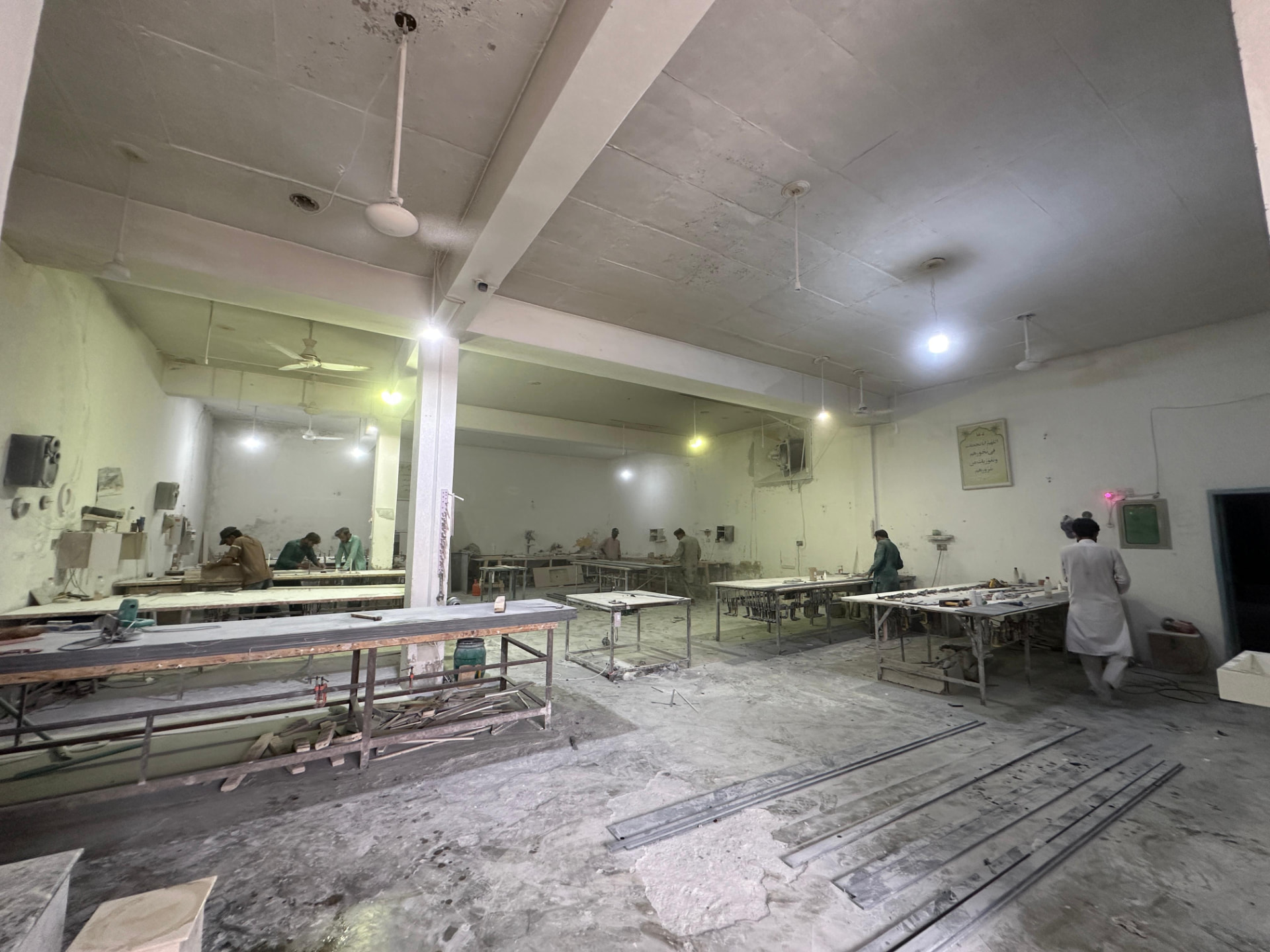 Style Concept fabrication floor with workbenches and craftsmen at work